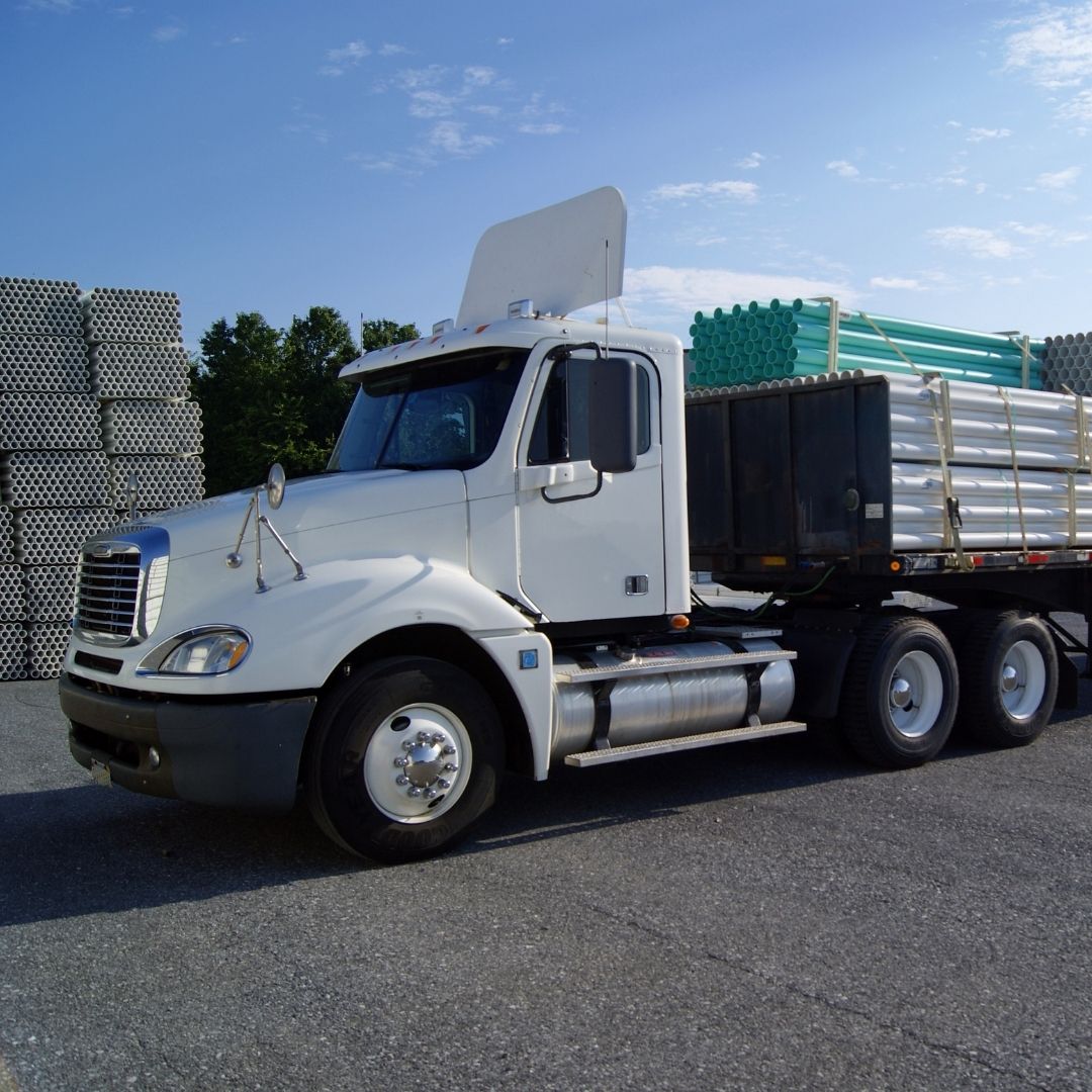 flatbed trailer loaded with pipes